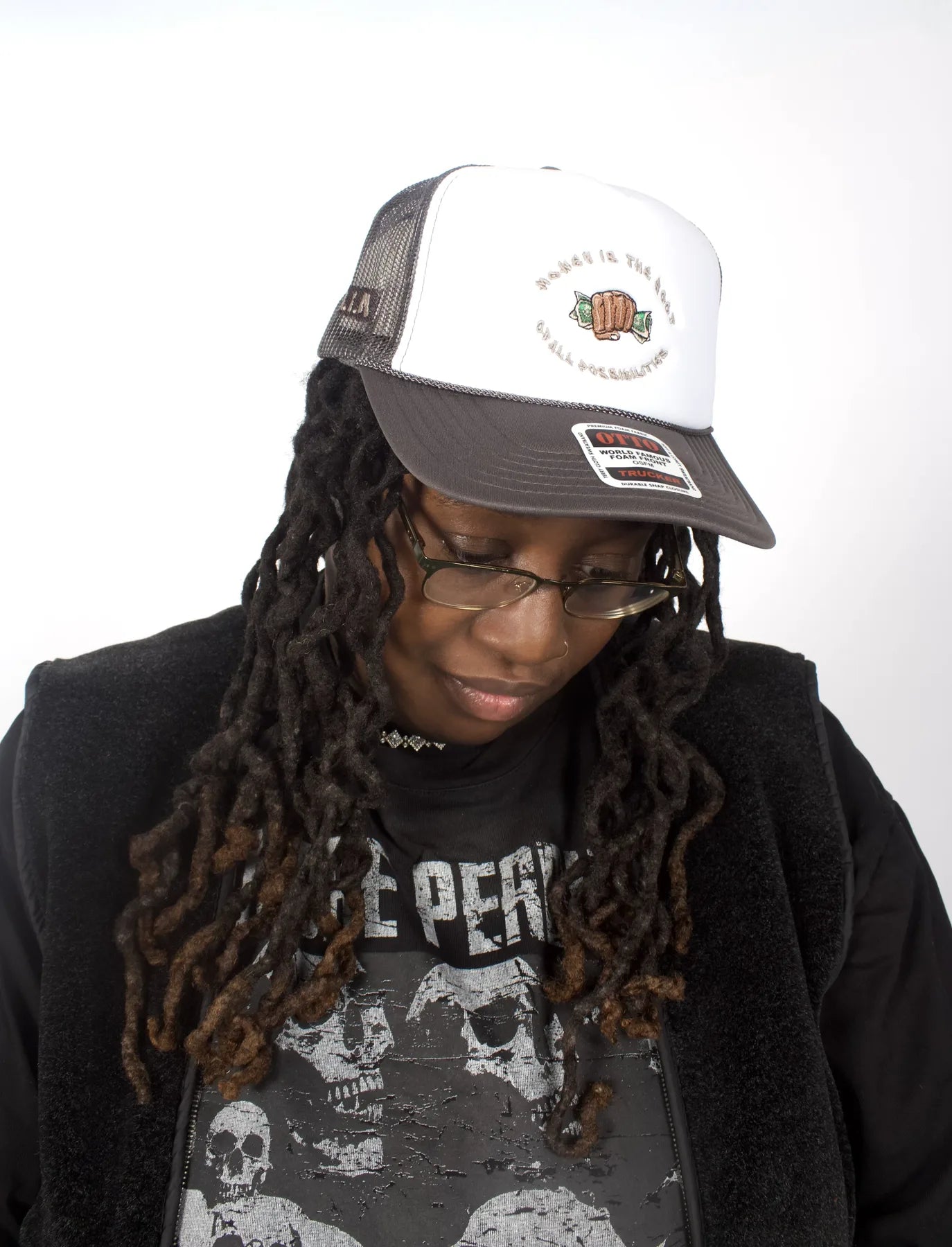Model wearing the black and white Money Is the Root of All Possibilities hat